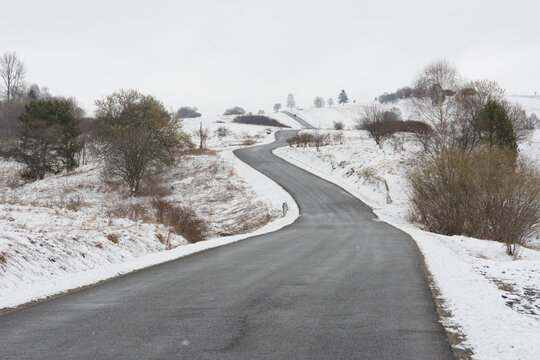 Winter landscape with a road winding between hills