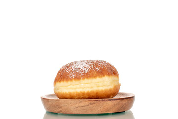 One sweet donut stuffed with jam  on a wooden saucer, close-up, isolated on a white background.