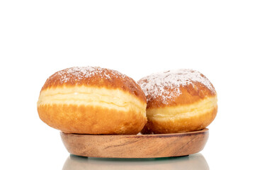 Two sweet donuts stuffed with jam on a wooden saucer, close-up, isolated on a white background.