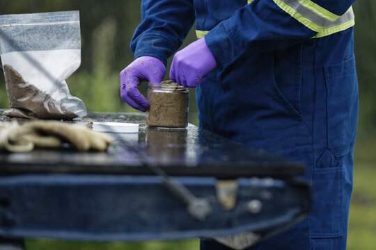 Closeup Shot Of The Professional Worker Testing And Sampling Oil Sands Tailing Ponds