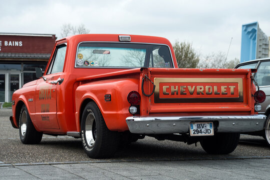 Lutterbach - France - 3 April 2022 - Rear view of orange chevrolet pick up  parked in the street