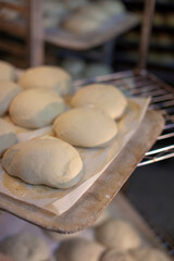 Fototapeta na wymiar Baking sheet with raw dough buns ready for baking