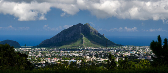 Panoramic view of Port Louis, Mauritius against a high rocky mountain - obrazy, fototapety, plakaty