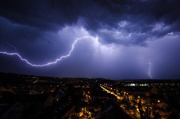 Beautiful scene of the lightning striking in the night sky over Stuttgart, Germany