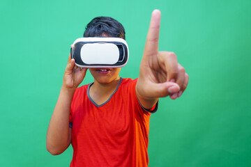 boy using virtual reality simulator headset on green background