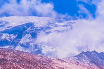 snow covered mountains and clouds on the mountains.