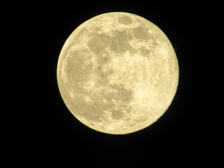 Focused shot of the full moon on the black background. © Wirestock Creators
