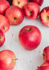Fresh red apples on a white wooden background. Side view.