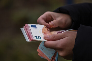 Woman counting euro banknotes