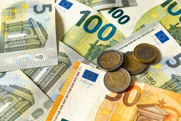 Pile of euro coins on euro banknotes.