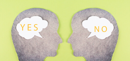 Head silhouettes with speech bubbles, words yes and no, communication between people, business and...