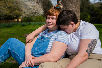 Lesbian couple sitting in the park.