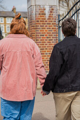 Lesbian couple walking holding hands.