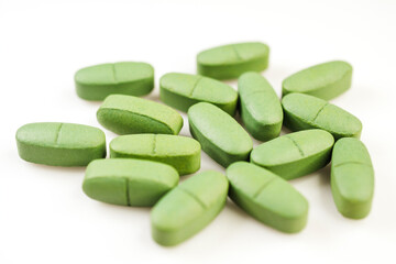 Fototapeta na wymiar Green pain pills isolated on a white