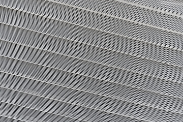 Background of wavy metallic grid with holes. Metal mesh as back. Perforated metal back.