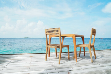 Outdoor terrace with Empty  wooden table and chair with Sea view of Indain ocean, Maldives background