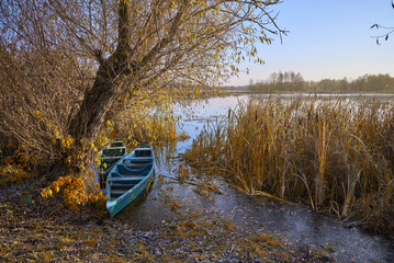 two boats in the bush on the river in the autumn moning in Ukraine	