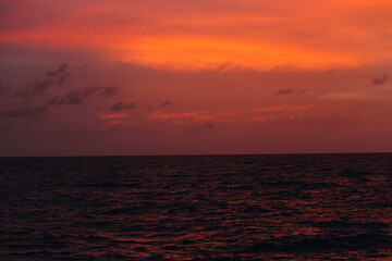 ocean at sunset, not big waves, horizontal