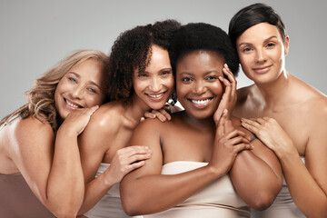 Youll never guess our age. Shot of a diverse group of women standing and hugging each other in the...