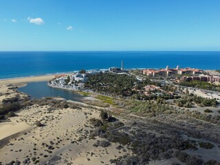 Fototapeta premium Aerial drone. Popular resort town of Meloneras, with hotels and restaurants, near the Maspalomas dunes in Gran Canaria, Canary Islands, Spain