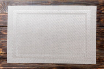 Top view of grey tablecloth for food on wooden background. Empty space for your design