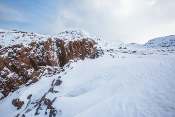 Fototapeta na wymiar Snow desert and rocks. Winter landscape near Teriberka. Russia