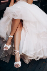 bride's legs in elegant shoes close-up