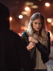 Shes got a bad feeling. Cropped shot of a frightened young woman being targeted by a thief.