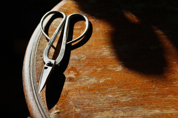 bonsai scissors on a rustic wooden table vintage distressed