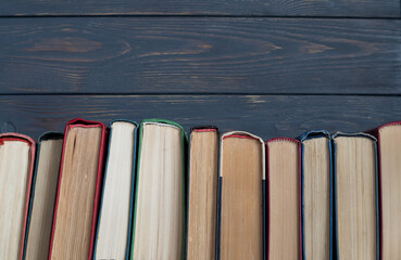 A stack of books on a gray wooden background. the concept of reading books on paper.