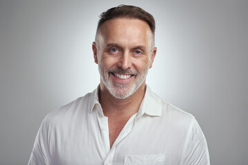 Be confident in who you are. Studio portrait of a mature man standing against a grey background.