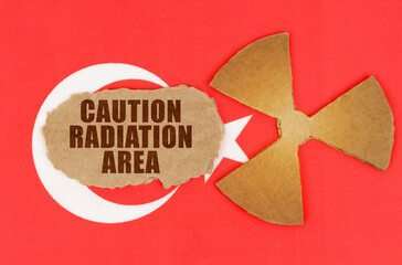 On the flag of Turkey, the symbol of radioactivity and torn cardboard with the inscription -...