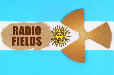 On the flag of Argentina, the symbol of radioactivity and torn cardboard with the inscription -...