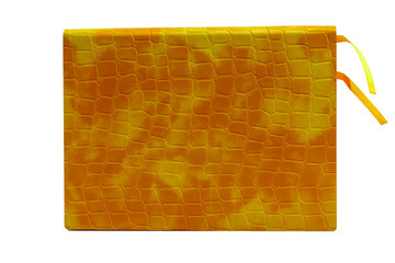 A notebook with a cover of artificial crocodile skin of yellow color on a white background. Isolate