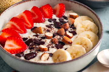 Close up of millet porridge with fruit, chocolate and nuts
