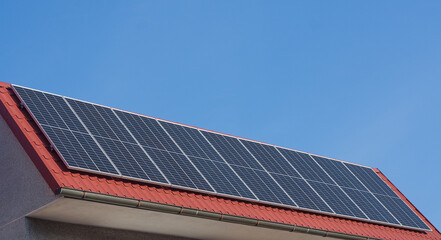 Fototapeta premium solar panels on red roof