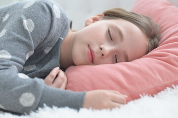 Fototapeta na wymiar cute little girl sleeping in bed at home
