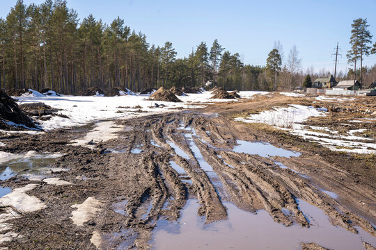 spring blurred country road with puddles and mud