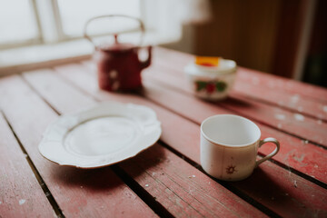 the red kitchen table of an abandoned farmhouse