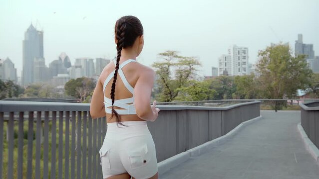 Young fitness woman in sportswear jogging in city park, Healthy and Lifestyles.