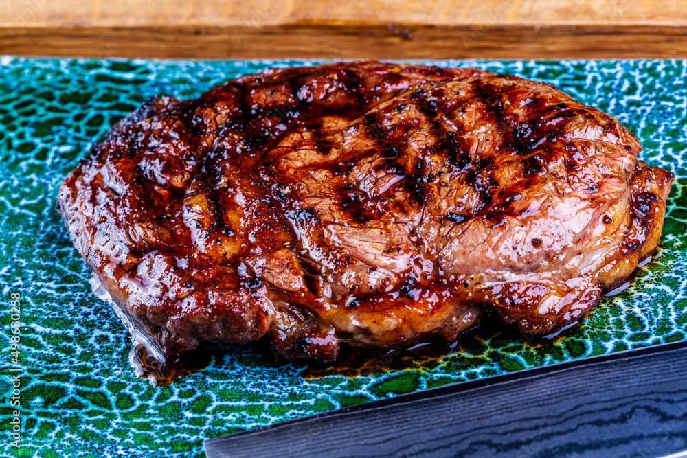 Wall mural Beef rib-eye steak. Close up