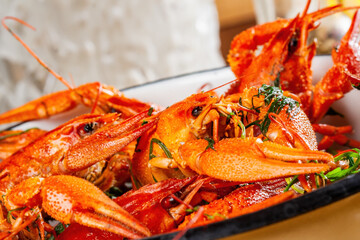 Boiled crawfish or crayfish with herbs in a white plate