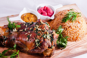 German style roasted pork hock (knuckle, shank) with rice on wooden cutting board
