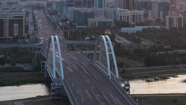 Sunset timelapse above the Bridge with the transport and clouds on the background. Central Asia, Kazakhstan, Astana
