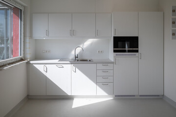 in the white room is installed a kitchenette