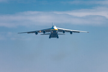 Huge cargo plane is approaching the runway and is about to land on an airport in Ljubljana, Slovenia. Freighter jet descending towards the airfield.
