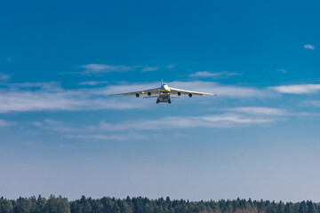 Fototapeta na wymiar Huge cargo plane is approaching the runway and is about to land on an airport in Ljubljana, Slovenia. Freighter jet descending towards the airfield.