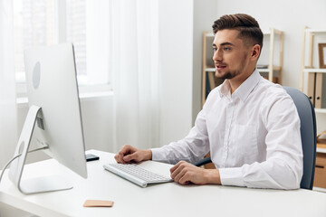 Fototapeta premium handsome businessman in a white shirt at the office work workplace