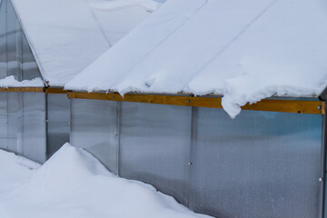 greenhouse under the snow in winter