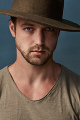 Hats are a great accessory to elevate your style. Studio portrait of a handsome young man wearing a hat against a dark background.